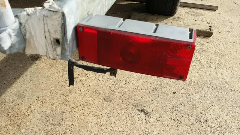 Slide: The Image of Red trailer light on a 1982 Starwind 19, mounted on a metal frame. - 34