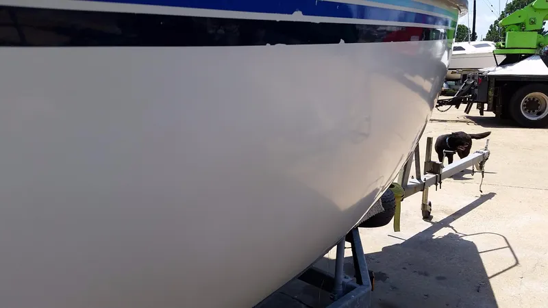 Slide: The Image of 1982 Starwind 19 sailboat hull on trailer, side view in sunlight. - 9