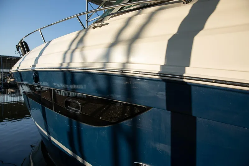 Slide: The Image of 2016 Sea Ray 350 Sundancer boat with cushioned deck, docked at marina. - 10