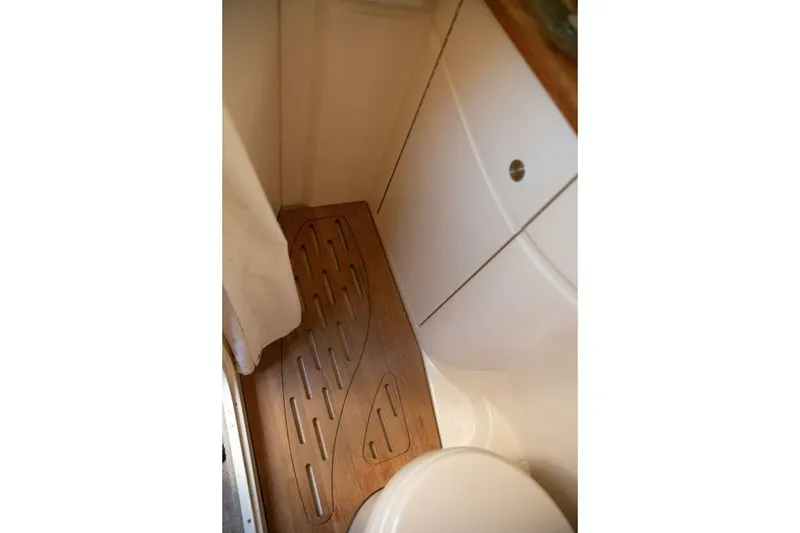 Slide: The Image of 2016 Sea Ray 350 Sundancer yacht kitchen with microwave, sink, and compact appliances. - 102