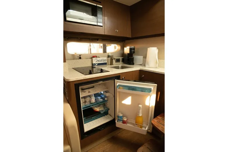 Slide: The Image of Kitchen area of 2016 Sea Ray 350 Sundancer with sink, stove, and coffee maker. - 106