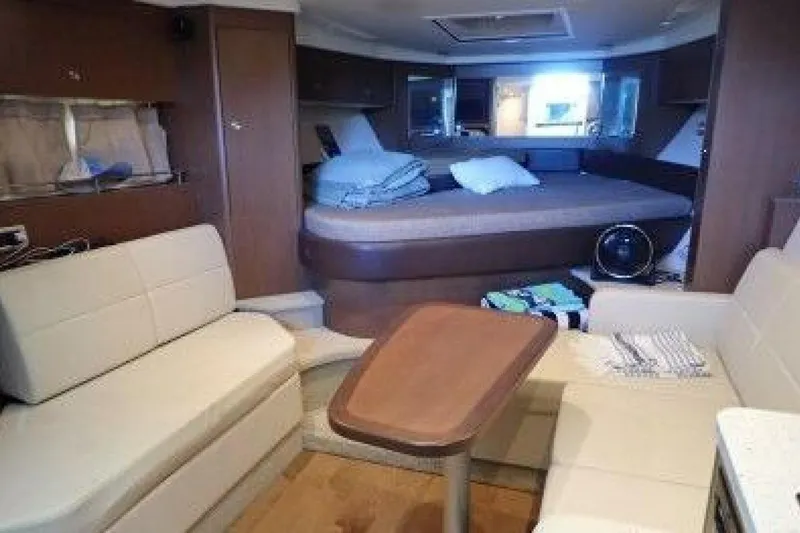 Slide: The Image of Interior of 2016 Sea Ray 350 Sundancer with beige seating and wooden flooring. - 108