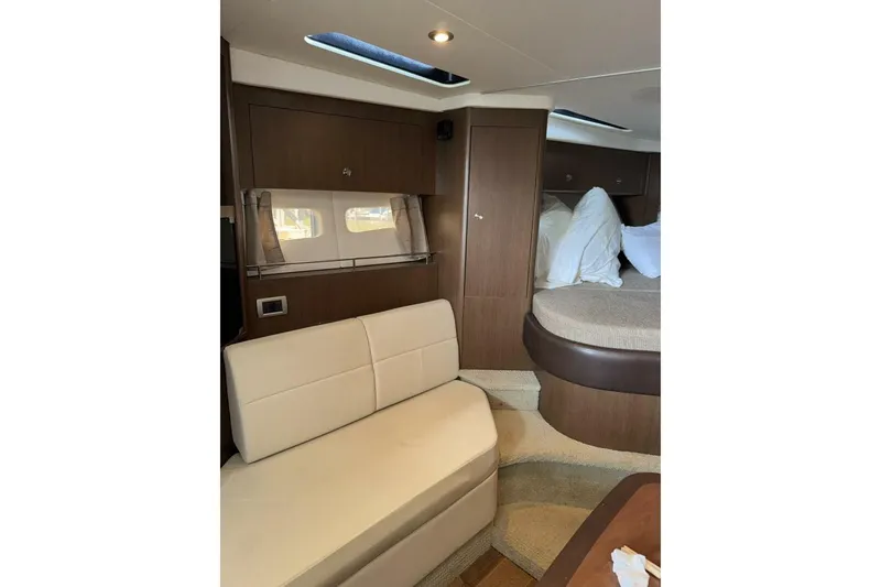 Slide: The Image of Interior of 2016 Sea Ray 350 Sundancer yacht with modern amenities and wooden accents. - 112