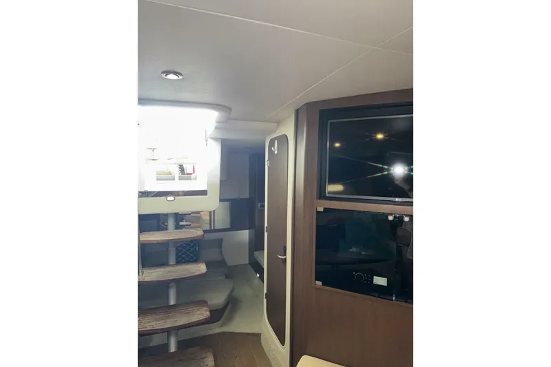 Slide: The Image of Interior of 2016 Sea Ray 350 Sundancer yacht with modern seating and entertainment area. - 113