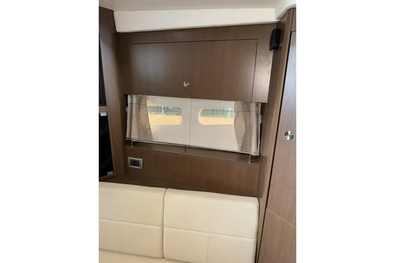 Slide: The Image of Interior of 2016 Sea Ray 350 Sundancer with window, curtains, and hats on shelf. - 119