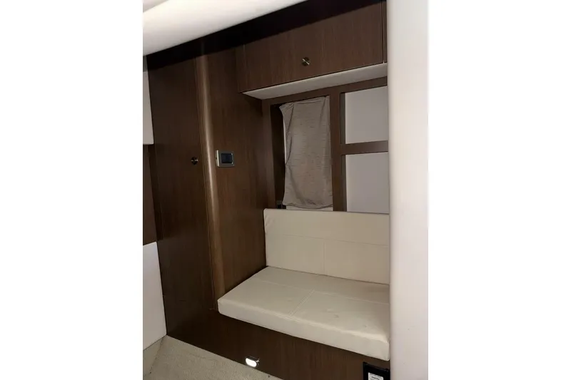Slide: The Image of Interior cabin of 2016 Sea Ray 350 Sundancer with cozy bedding and porthole window. - 122