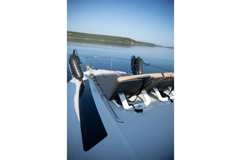 Slide: The Image of 2016 Sea Ray 350 Sundancer docked under a metal canopy with scenic lake view. - 15