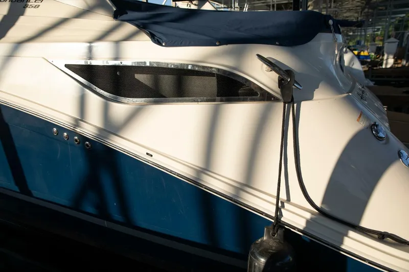 Slide: The Image of 2016 Sea Ray 350 Sundancer docked in a marina, side view. - 19