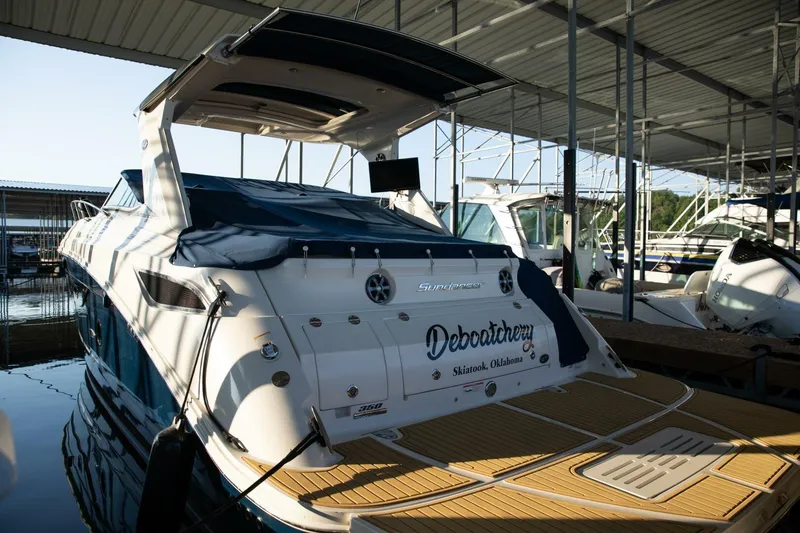 Slide: The Image of 2016 Sea Ray 350 Sundancer boat side view with shadows and docked rope. - 20
