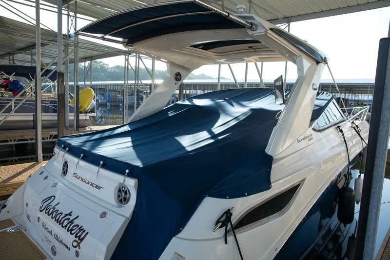 Slide: The Image of 2016 Sea Ray 350 Sundancer docked in a marina, rear view. - 22