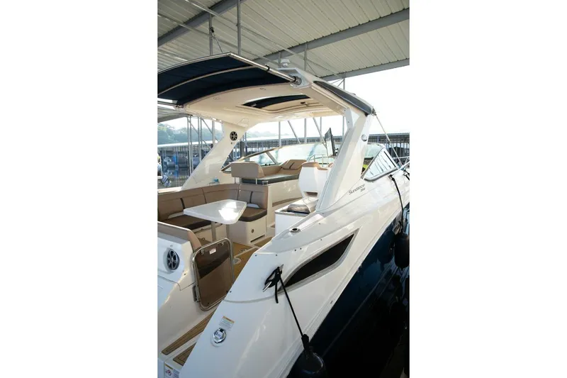 Slide: The Image of 2016 Sea Ray 350 Sundancer docked, featuring spacious seating and sleek design. - 27