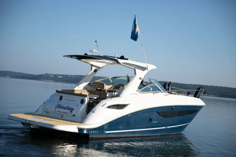 Slide: The Image of 2016 Sea Ray 350 Sundancer boat interior with lake view and seating area. - 36