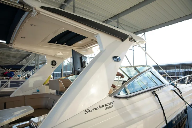 Slide: The Image of 2016 Sea Ray 350 Sundancer yacht docked under a covered marina. - 37
