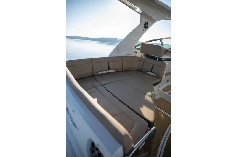 Slide: The Image of 2016 Sea Ray 350 Sundancer boat with beige seating on calm water. - 52