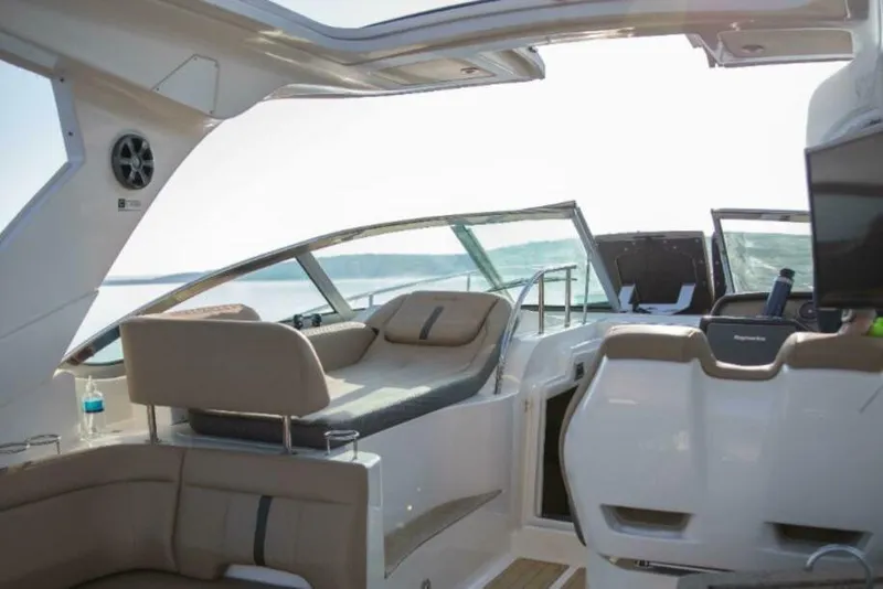 Slide: The Image of Luxurious seating on 2016 Sea Ray 350 Sundancer boat, featuring beige upholstery. - 54