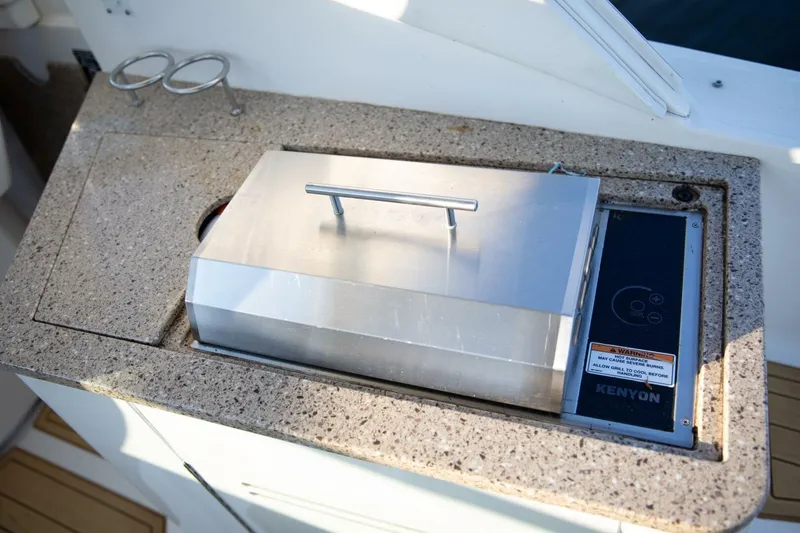 Slide: The Image of Interior of 2016 Sea Ray 350 Sundancer with cup holders and switch panel. - 57