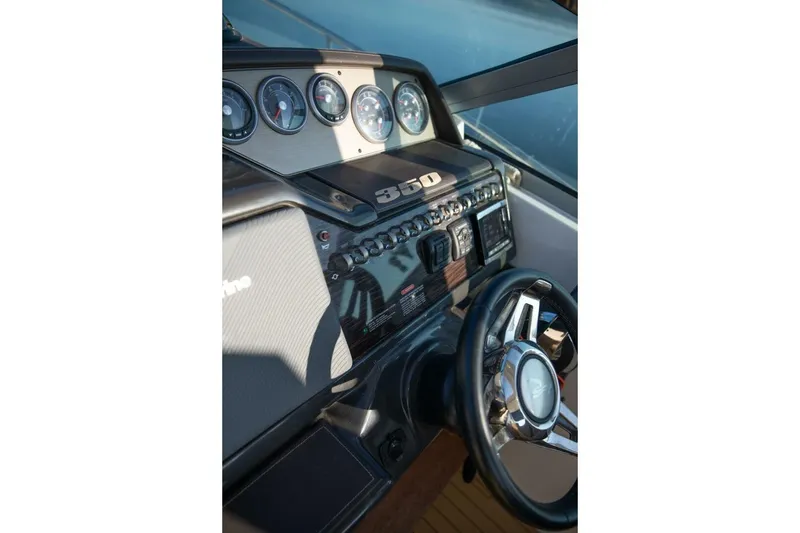 Slide: The Image of Steering wheel and dashboard of 2016 Sea Ray 350 Sundancer boat. - 66