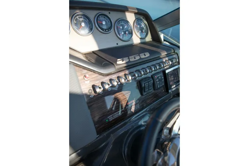 Slide: The Image of Control knob on 2016 Sea Ray 350 Sundancer boat dashboard with stickers and warning labels. - 68