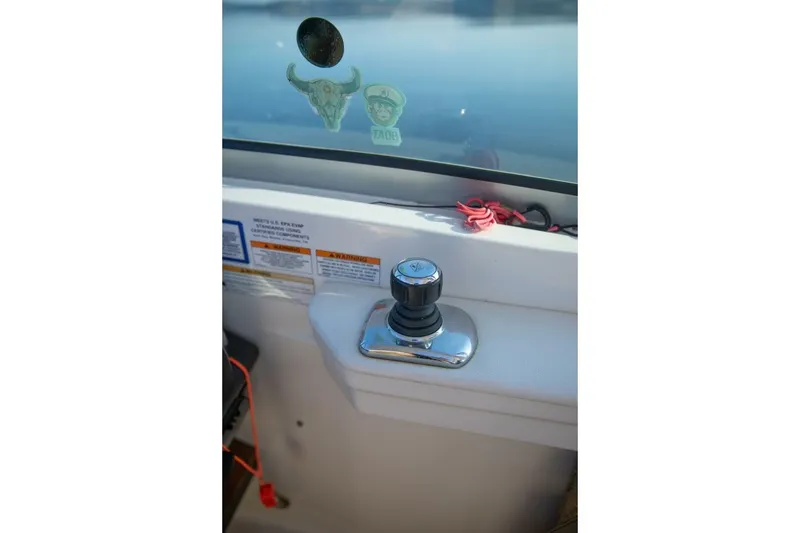 Slide: The Image of Joystick control on 2016 Sea Ray 350 Sundancer boat dashboard. - 69