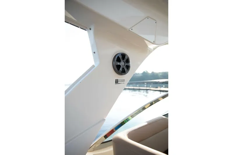 Slide: The Image of Interior view of 2016 Sea Ray 350 Sundancer boat with speaker and water backdrop. - 75