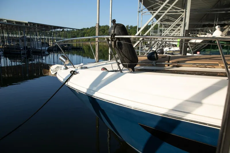 Slide: The Image of 2016 Sea Ray 350 Sundancer cabin interior with cozy bed and stylish decor. - 8