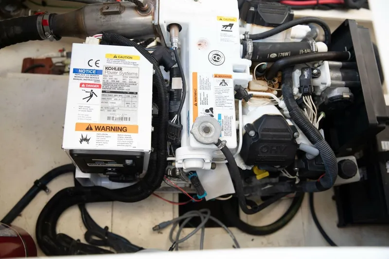 Slide: The Image of Engine compartment of 2016 Sea Ray 350 Sundancer showing battery and wiring setup. - 82