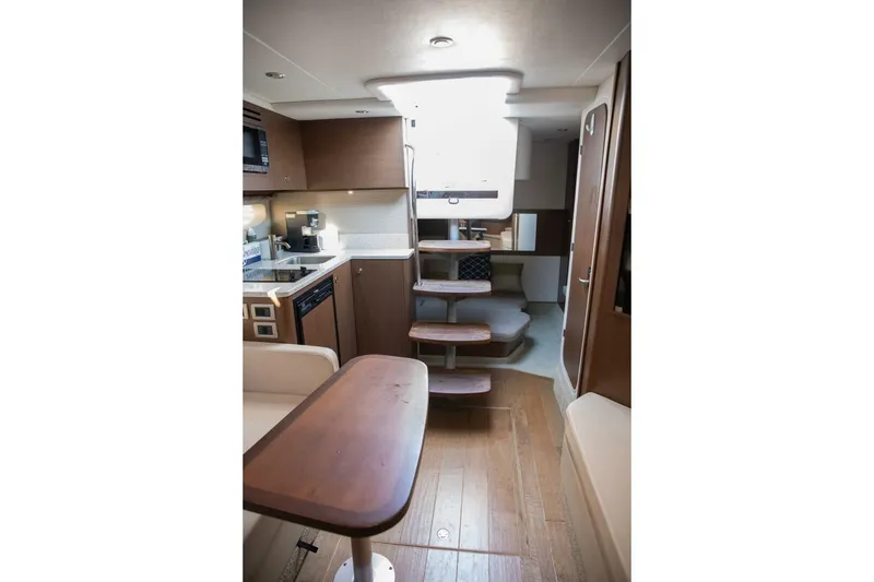 Slide: The Image of Interior of 2016 Sea Ray 350 Sundancer yacht with modern kitchen and seating area. - 89