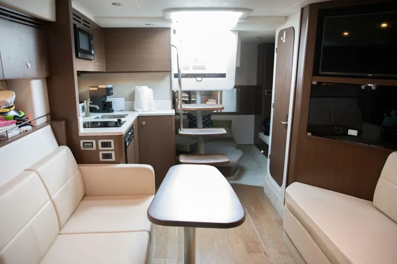 Slide: The Image of Interior of 2016 Sea Ray 350 Sundancer yacht with cozy seating and bed. - 91