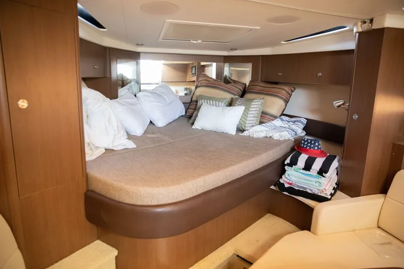 Slide: The Image of Interior cabin of 2016 Sea Ray 350 Sundancer with bed and storage cabinets. - 93
