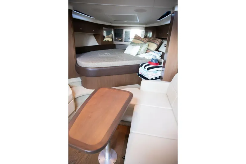 Slide: The Image of Interior of 2016 Sea Ray 350 Sundancer yacht, featuring a compact bathroom and seating area. - 95