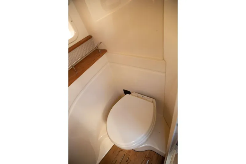 Slide: The Image of Interior of 2016 Sea Ray 350 Sundancer bathroom with sink and toilet. - 97