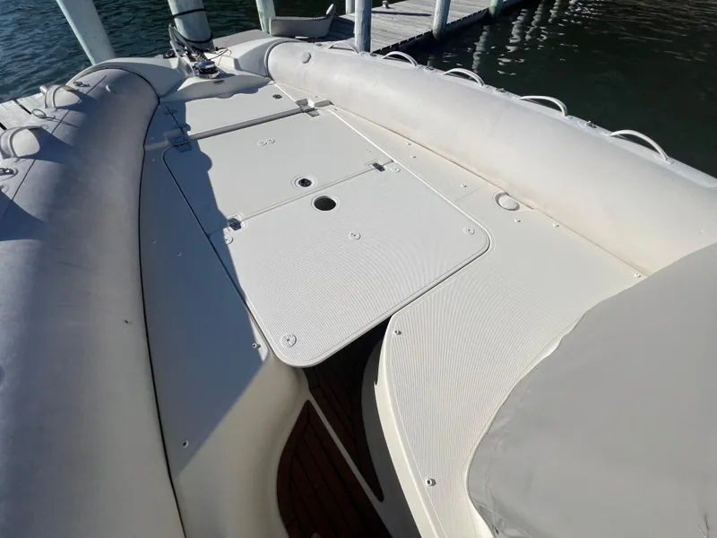 Slide: The Image of 2015 Zodiac N-ZO 760 boat deck with storage compartments, docked by the water. - 10