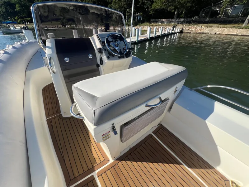 Slide: The Image of 2015 Zodiac N-ZO 760 boat interior with steering wheel and cushioned seating. - 12