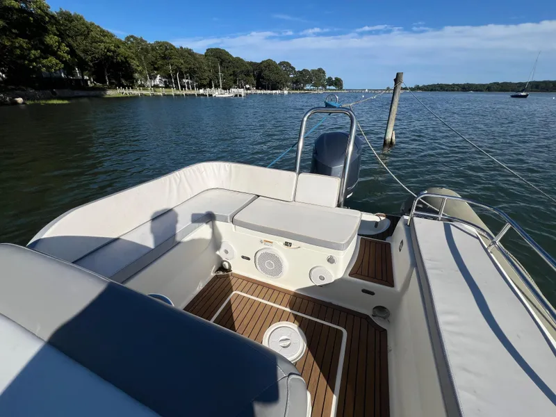 Slide: The Image of 2015 Zodiac N-ZO 760 boat interior with seating, on a calm lake. - 16