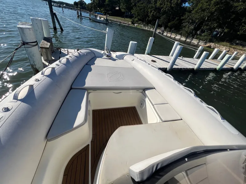 Slide: The Image of 2015 Zodiac N-ZO 760 boat docked by a wooden pier on a sunny day. - 19