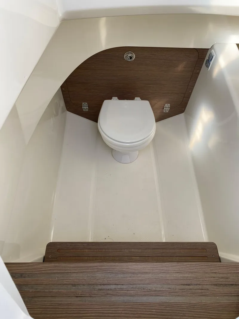 Slide: The Image of 2015 Zodiac N-ZO 760 boat interior with a compact marine toilet. - 22