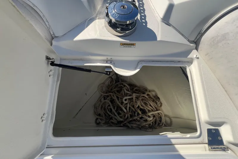 Slide: The Image of Open storage compartment on 2015 Zodiac N-ZO 760 boat with coiled rope inside. - 27