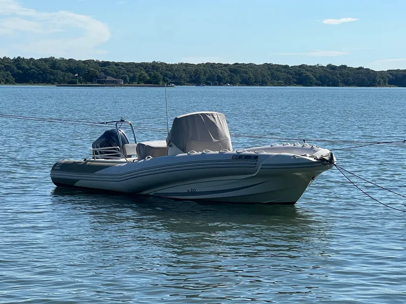 Slide: The Image of 2015 Zodiac N-ZO 760 boat anchored on calm water with scenic background. - 5