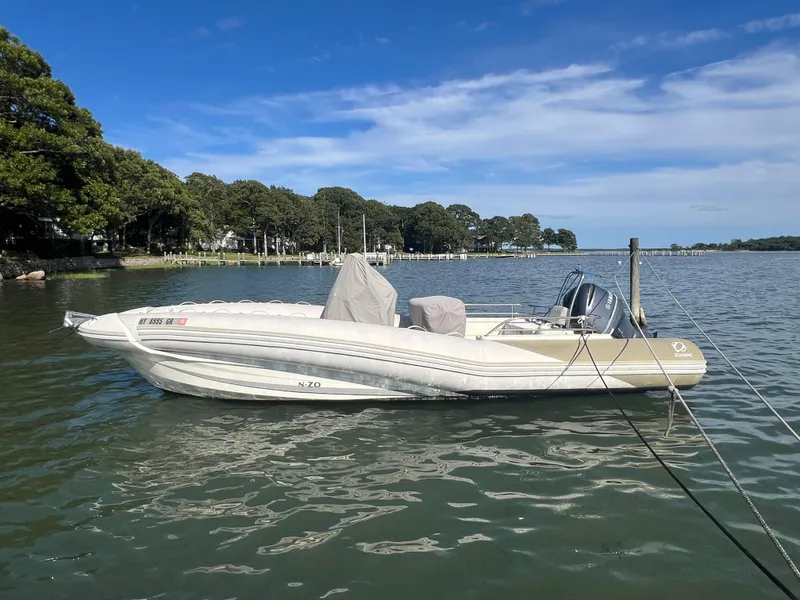 Slide: The Image of 2015 Zodiac N-ZO 760 boat moored on a calm lake under a clear blue sky. - 6