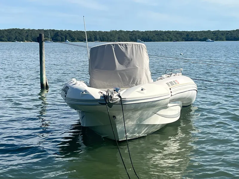 Slide: The Image of 2015 Zodiac N-ZO 760 boat moored on calm water with forested shoreline. - 8