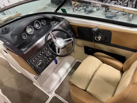Slide: The Image of 2015 Sea Ray 250 SLX boat interior with steering wheel and control panel. - 12