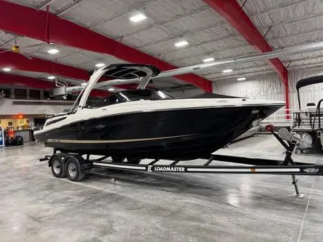 Slide: The Image of 2015 Sea Ray 250 SLX boat on Loadmaster trailer in indoor facility. - 13