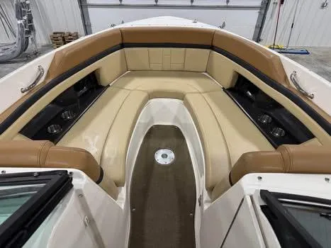 Slide: The Image of 2015 Sea Ray 250 SLX boat interior with tan leather seating and cup holders. - 9