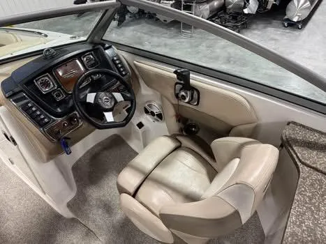 Slide: The Image of 2011 Chaparral 264 Sunesta boat interior with steering wheel and control panel. - 10