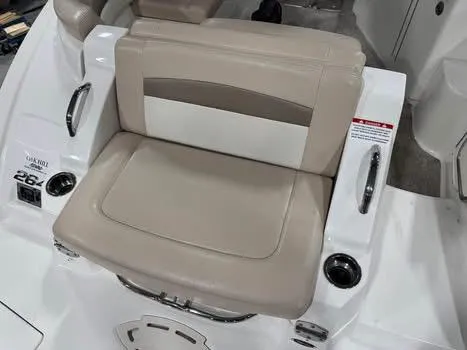 Slide: The Image of 2011 Chaparral 264 Sunesta boat seat with beige and white upholstery. - 12