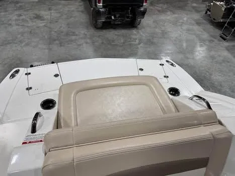 Slide: The Image of 2011 Chaparral 264 Sunesta boat interior with beige seating and cup holders. - 13