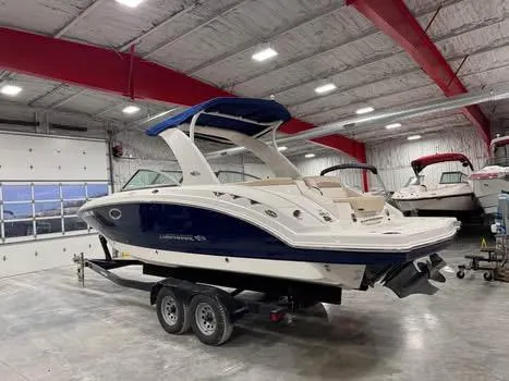 Slide: The Image of 2011 Chaparral 264 Sunesta boat in a spacious indoor storage facility. - 4