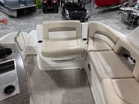 Slide: The Image of 2011 Chaparral 264 Sunesta boat interior with beige seating and kitchenette. - 7