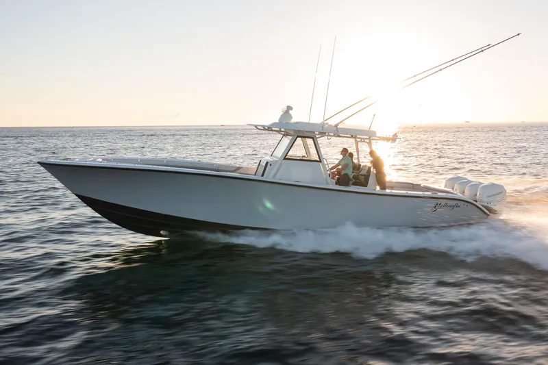 Slide: The Image of 2019 Yellowfin 39 boat cruising on open water at sunset. - 10