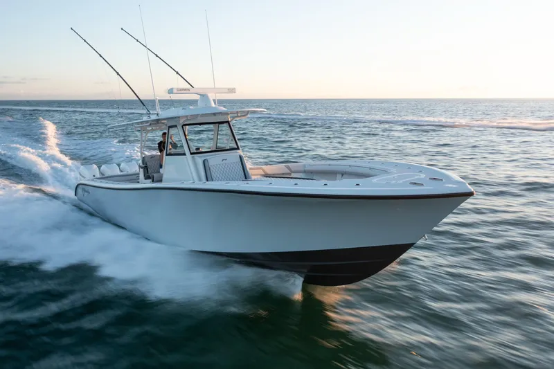 Slide: The Image of 2019 Yellowfin 39 boat cruising on open water at sunset. - 7